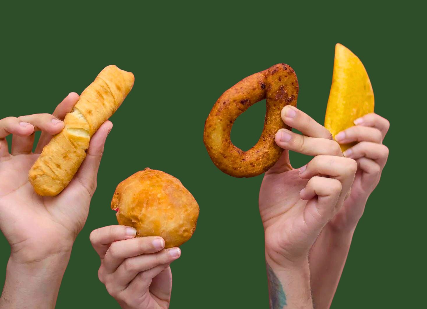 person holding brown bread with yellow sliced fruit